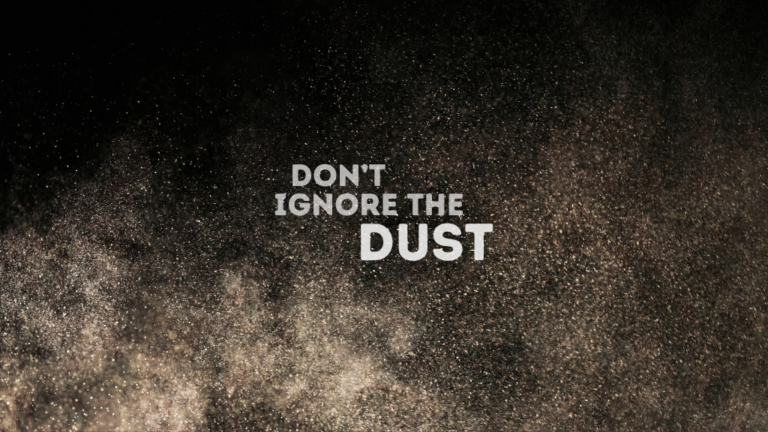 Dust particles in the air against a black background