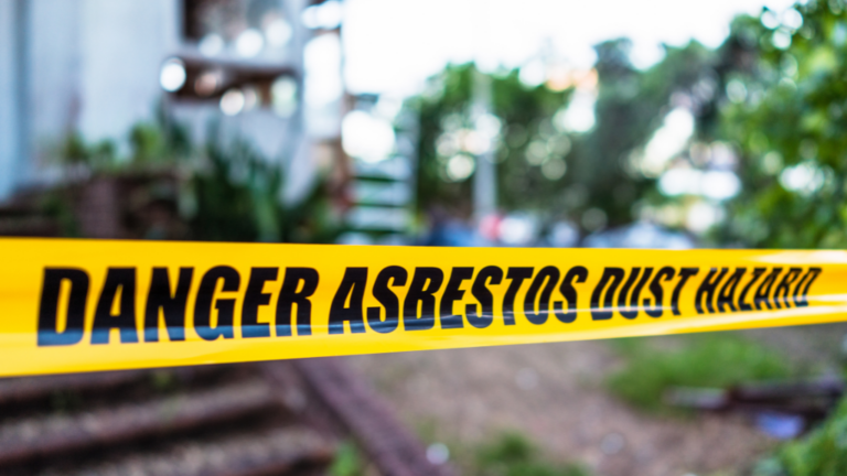 Yellow Hazard Tape that says Danger Asbestos